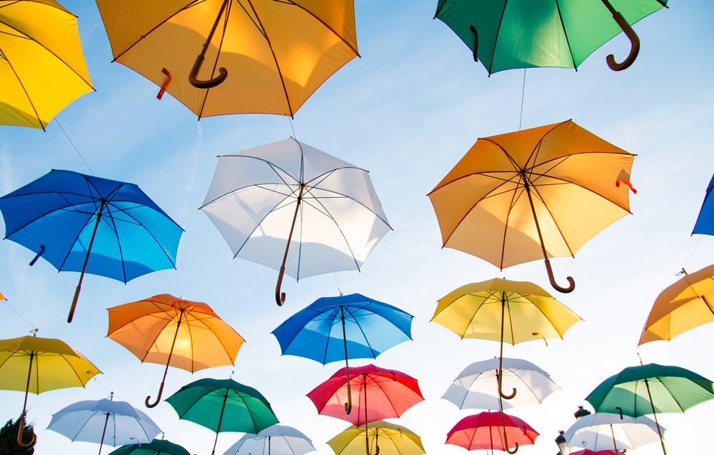 many colourful umbrellas in the sky